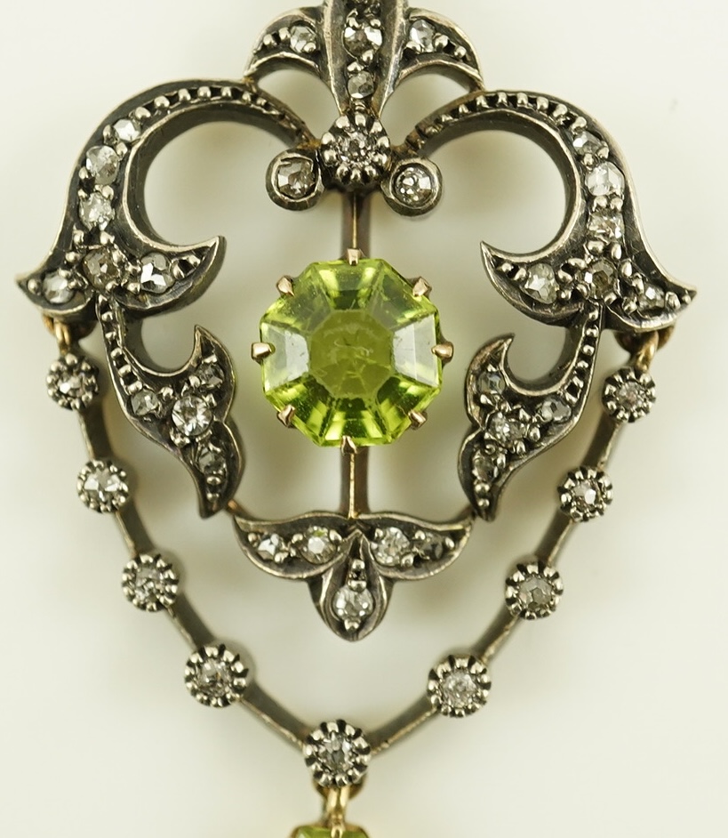 A Victorian gold and silver, peridot and diamond cluster set articulated drop pendant